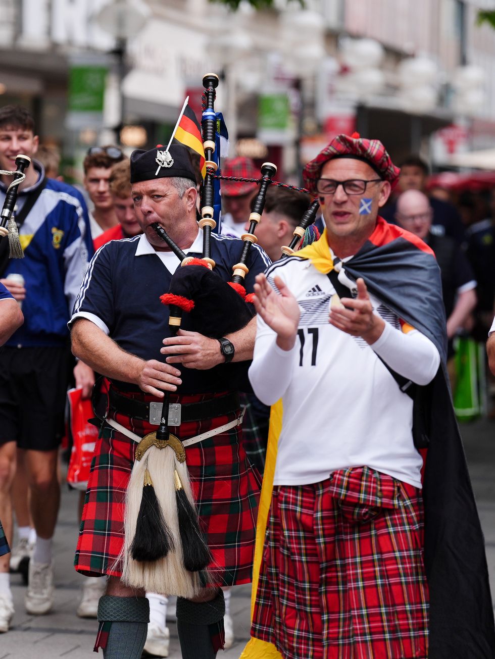 Scotland and Germany fans with pipers at Marienplatz square, Munich