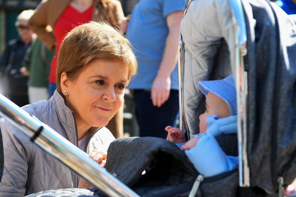 Scotland's First Minister Nicola Sturgeon speaks with a toddler as she visits Partick Farmer's Market , Glasgow, while on the council elections campaign trail. Picture date: Saturday April 23, 2022.