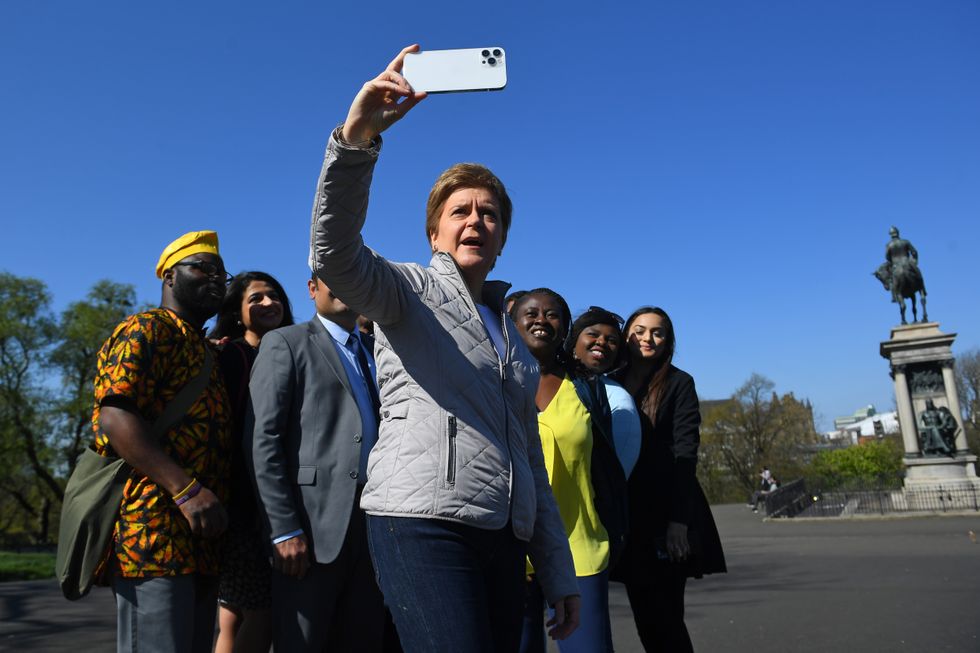Scotland's First Minister Nicola Sturgeon takes a selfie photograph with the Scottish National Party's (SNP's) BAME 'Black, Asian and minority ethnic' council election candidates in Kelvingrove Park, Glasgow. Picture date: Saturday April 23, 2022.