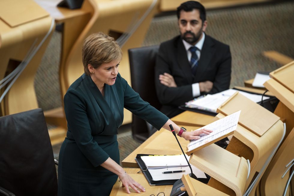 Scotland's First Minister Nicola Sturgeon, watched by Humza Yousaf, Cabinet Secretary for Health and Social Care, speaks during First Minster's Questions.