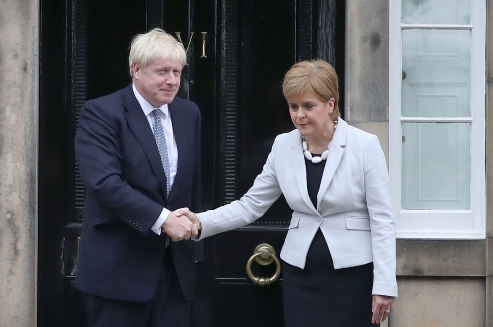 Scotland's First Minister Nicola Sturgeon welcomes Prime Minister Boris Johnson outside Bute House