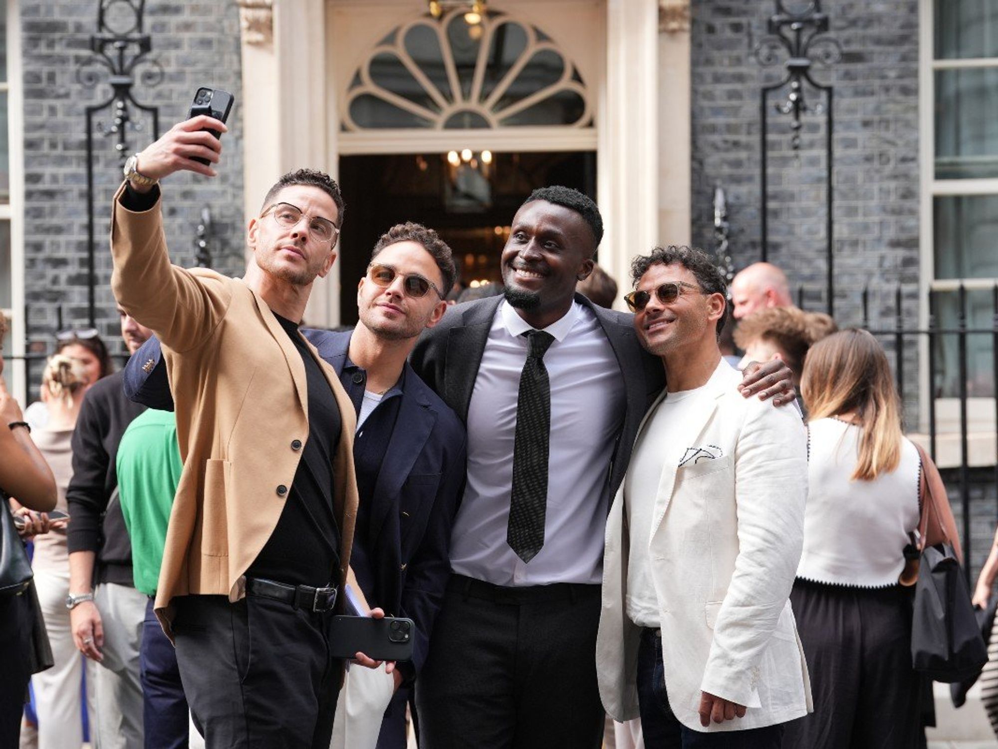 Scott Thomas (left), Adam Thomas (second left) and Ryan Thomas (right) pose for a selfie ahead of a reception hosted by Prime Minister Sir Keir Starmer for influencers at 10 Downing Street