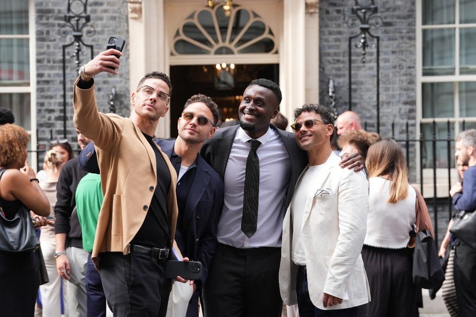 Scott Thomas (left), Adam Thomas (second left) and Ryan Thomas (right) pose for a selfie ahead of a reception hosted by Prime Minister Sir Keir Starmer for influencers at 10 Downing Street