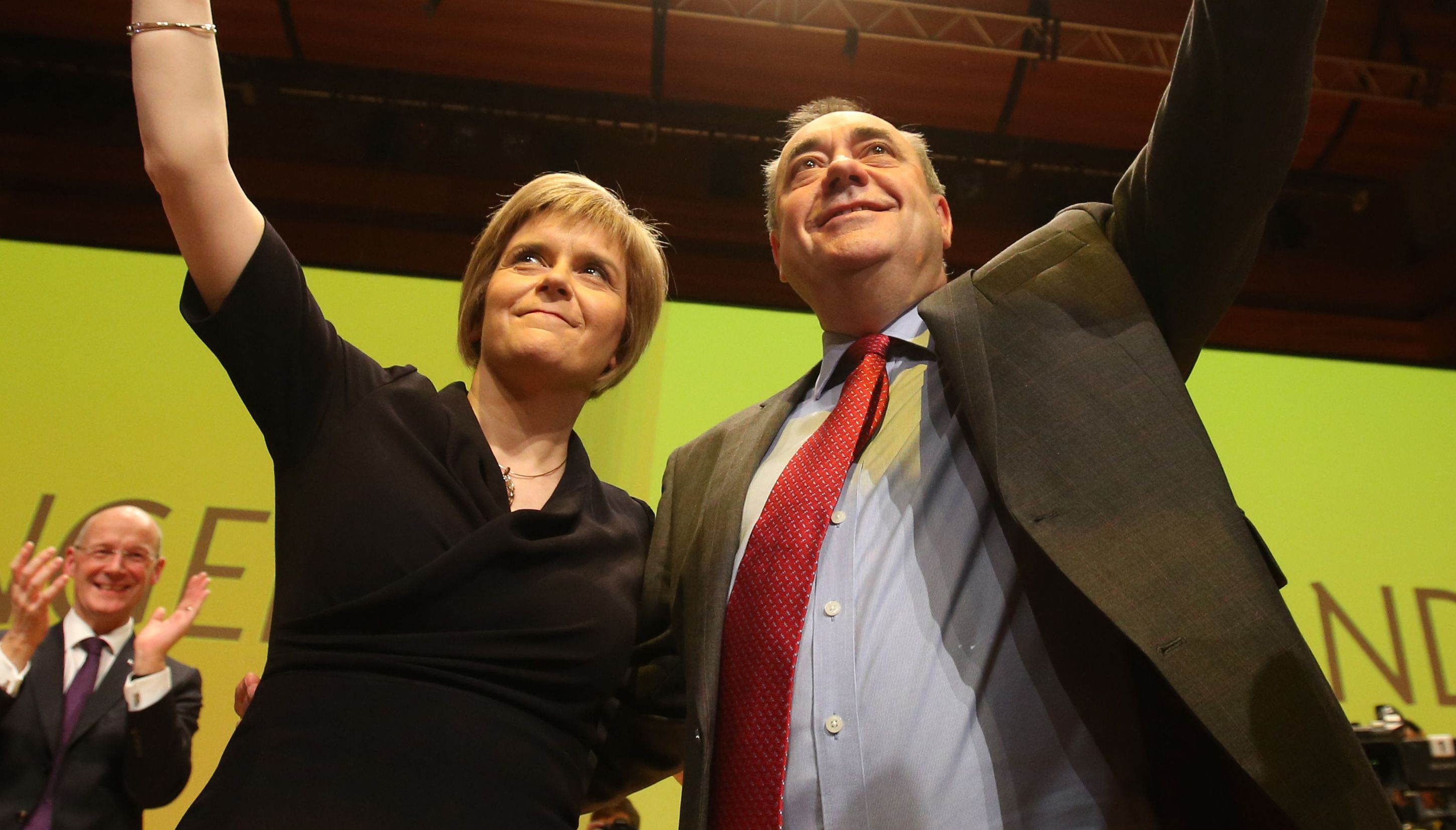 Scottish First Minister Alex Salmond is congratulated by new SNP leader Nicola Sturgeon following his speech at the annual party conference at Perth Concert Hall, Scotland.