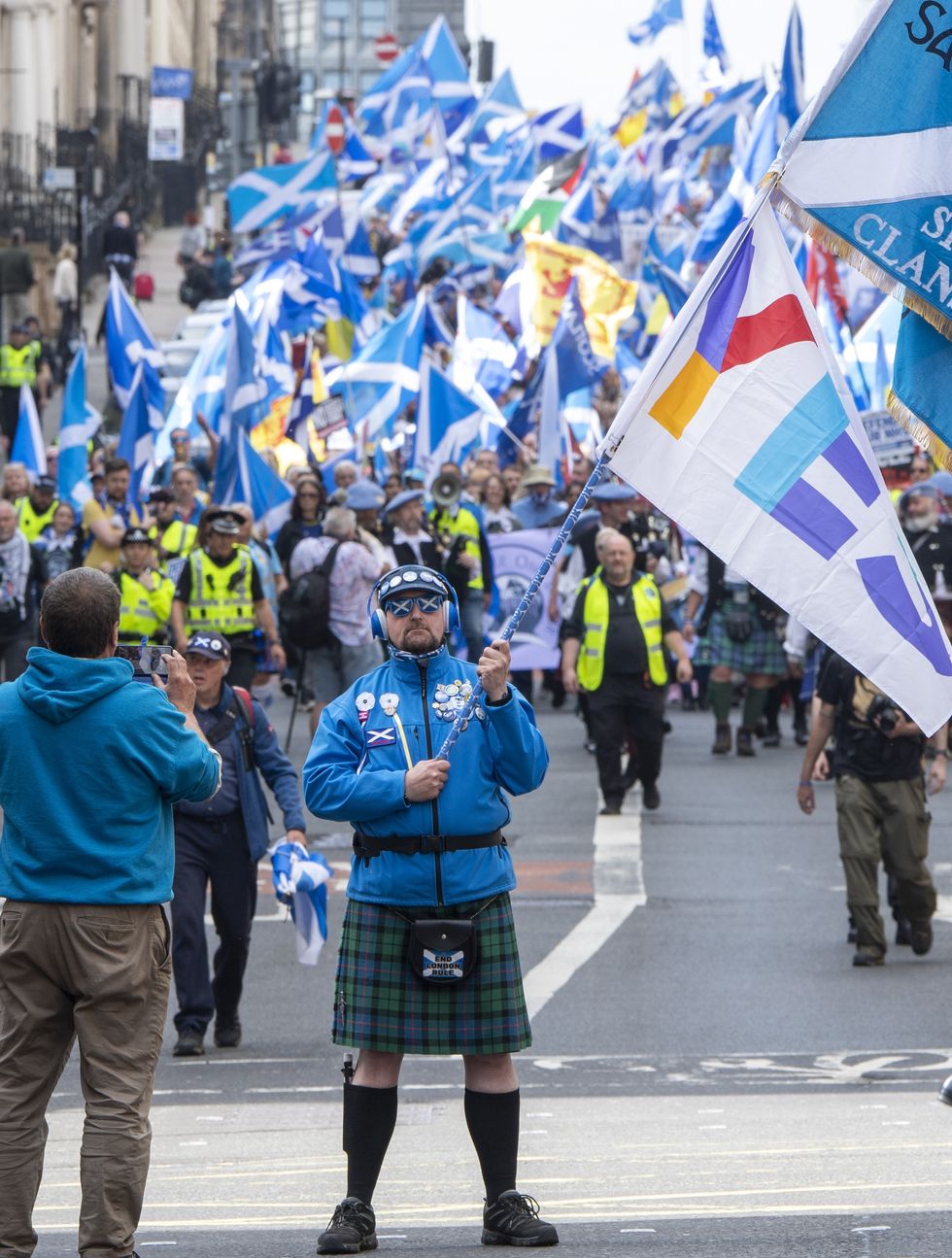 Scottish independence supporters march in Glasgow during the All Under One banner march
