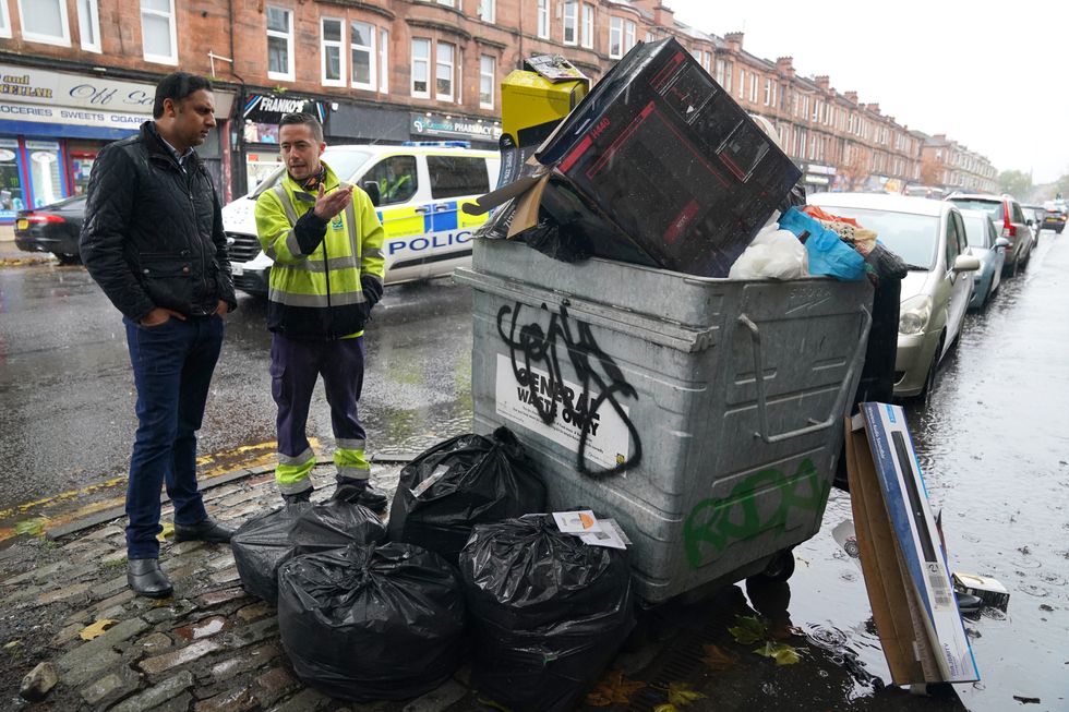 Scottish Labour leader Anas Sarwar is shown an overflowing bin by Barry McAreavey as he meets GMB cleansing workers in Glasgow to learn about their dispute with the Scottish Government ahead of Cop26.