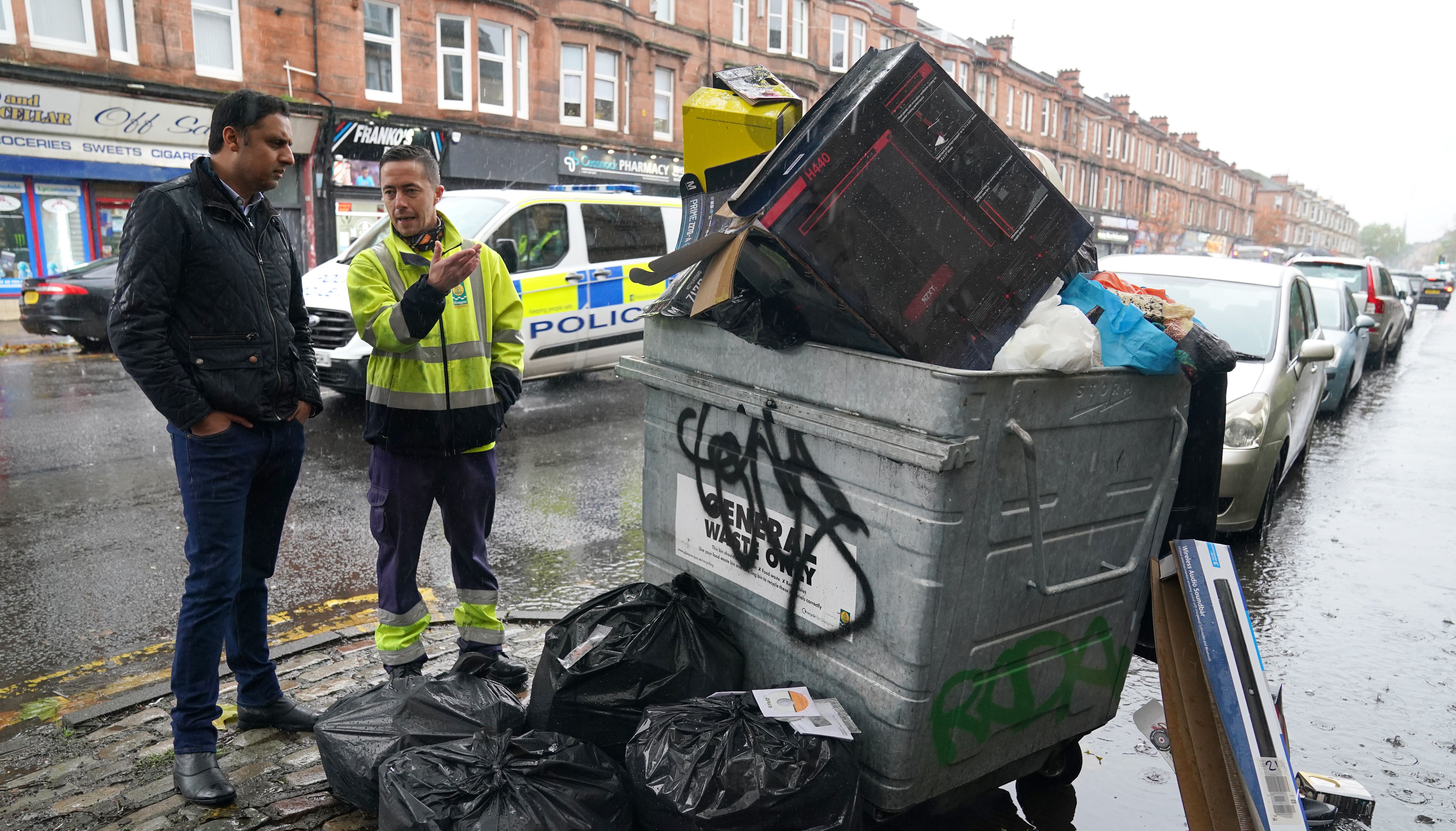 Scottish Labour leader Anas Sarwar is shown an overflowing bin by Barry McAreavey as he meets GMB cleansing workers in Glasgow to learn about their dispute with the Scottish Government ahead of Cop26.