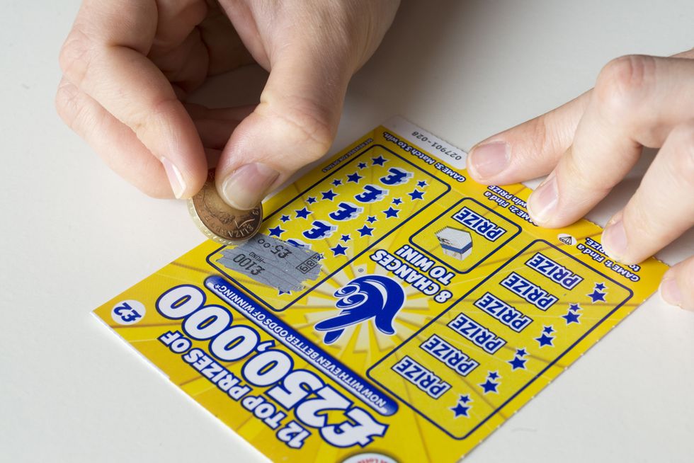 Scratching a National Lottery scratch card