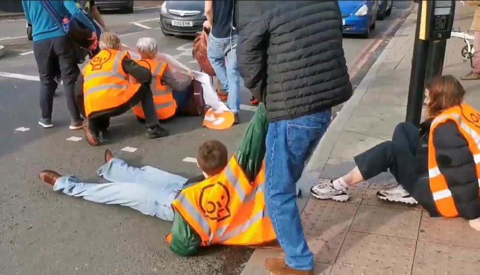 Screengrab from a video posted by Just Stop Oil of one of their activists being dragged off the street at Harleyford Street, just off Kennington Park Road, during their protest. Issue date: Saturday October 29, 2022.