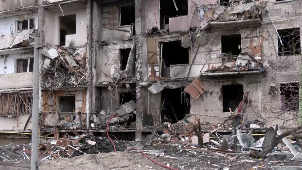 Screengrab from video shows a heavily damaged apartment building after overnight rocket attacks by Russian forces on the country's capital Kyiv, Ukraine February 25, 2022. Reuters TV via REUTERS
