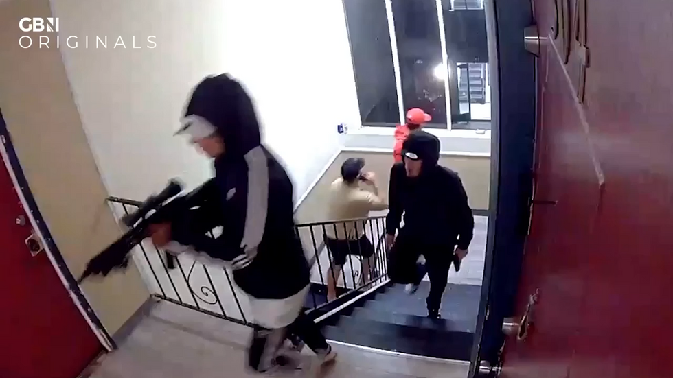 Screengrab of CCTV footage showed gang members storming the block with guns