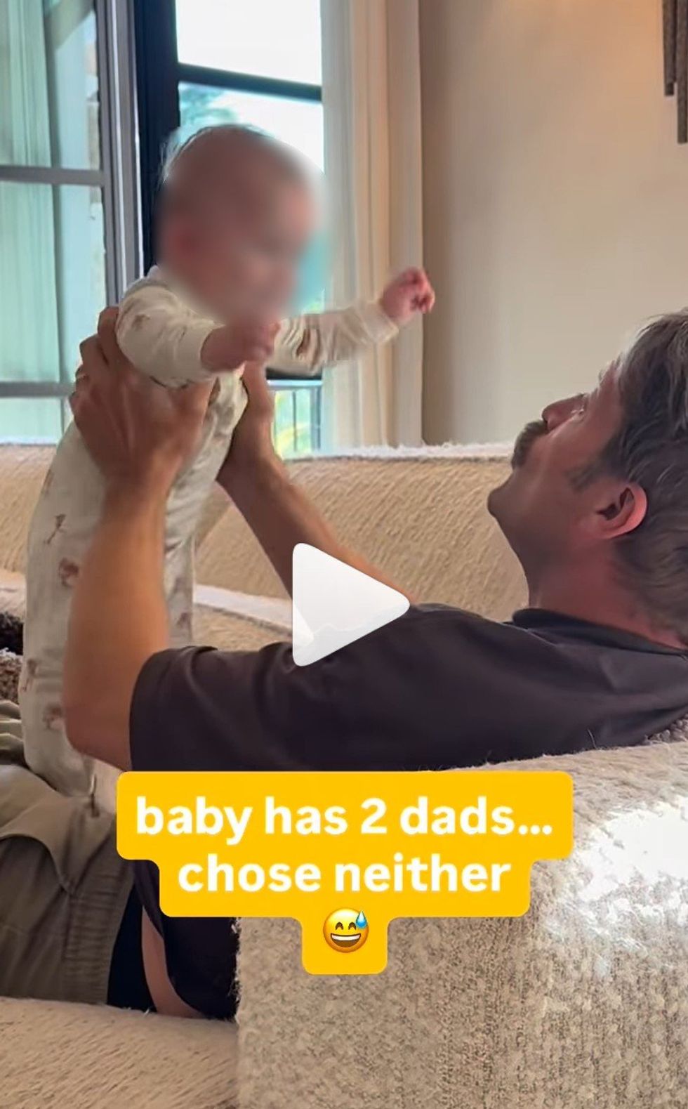 Screenshot shows Mr McAnally playing with the baby