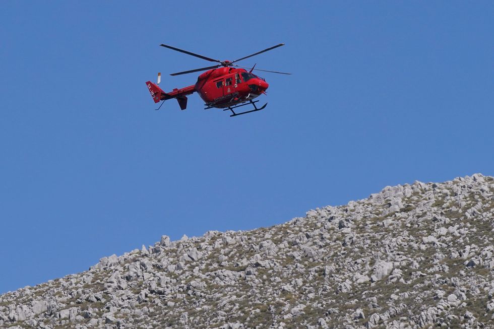 Search and rescue helicopter flying over the hills in Pedi