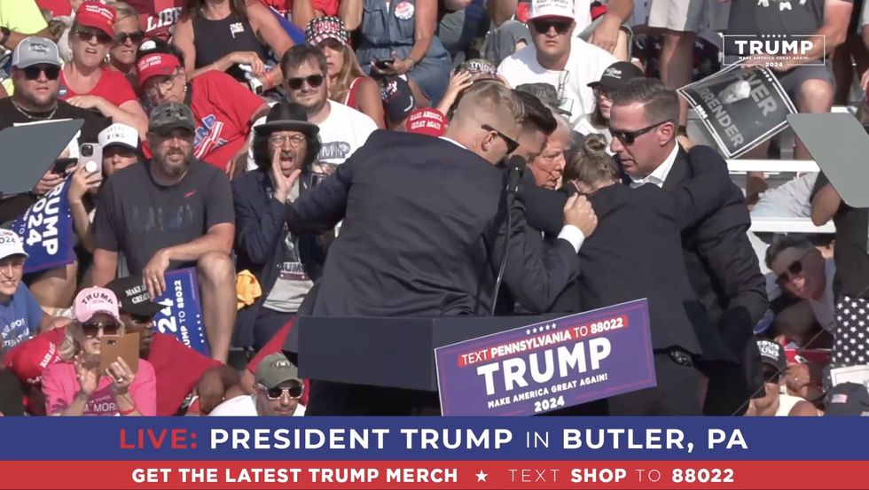 Secret Service form ring of steel around Trump and escort him from stage