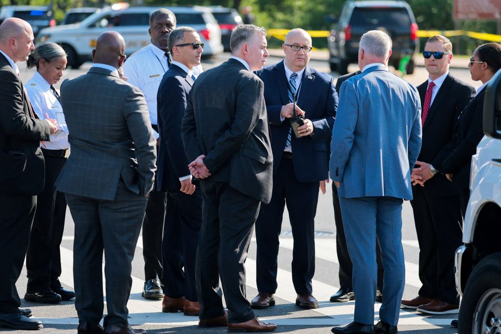 Secret Service personnel and police officers gather near the scene