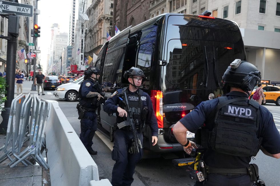 Security forces members stand guard outside Trump Tower after Trump was injured when shots were fired during a campaign rally held in Butler