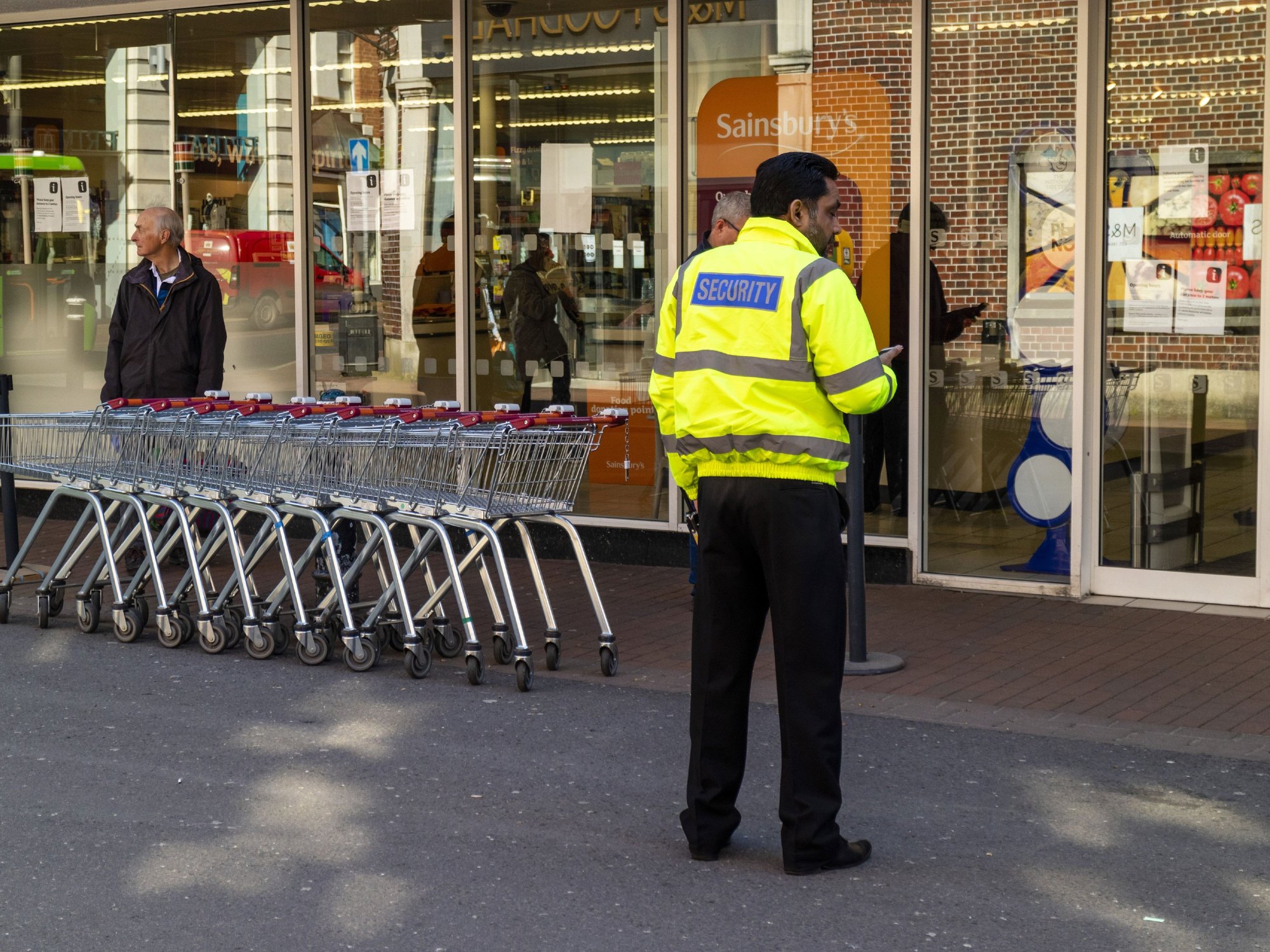 Security worker outside a Sainsbury's