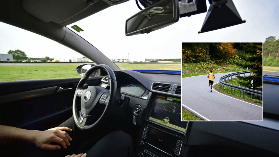 Self-driving car and runner on road
