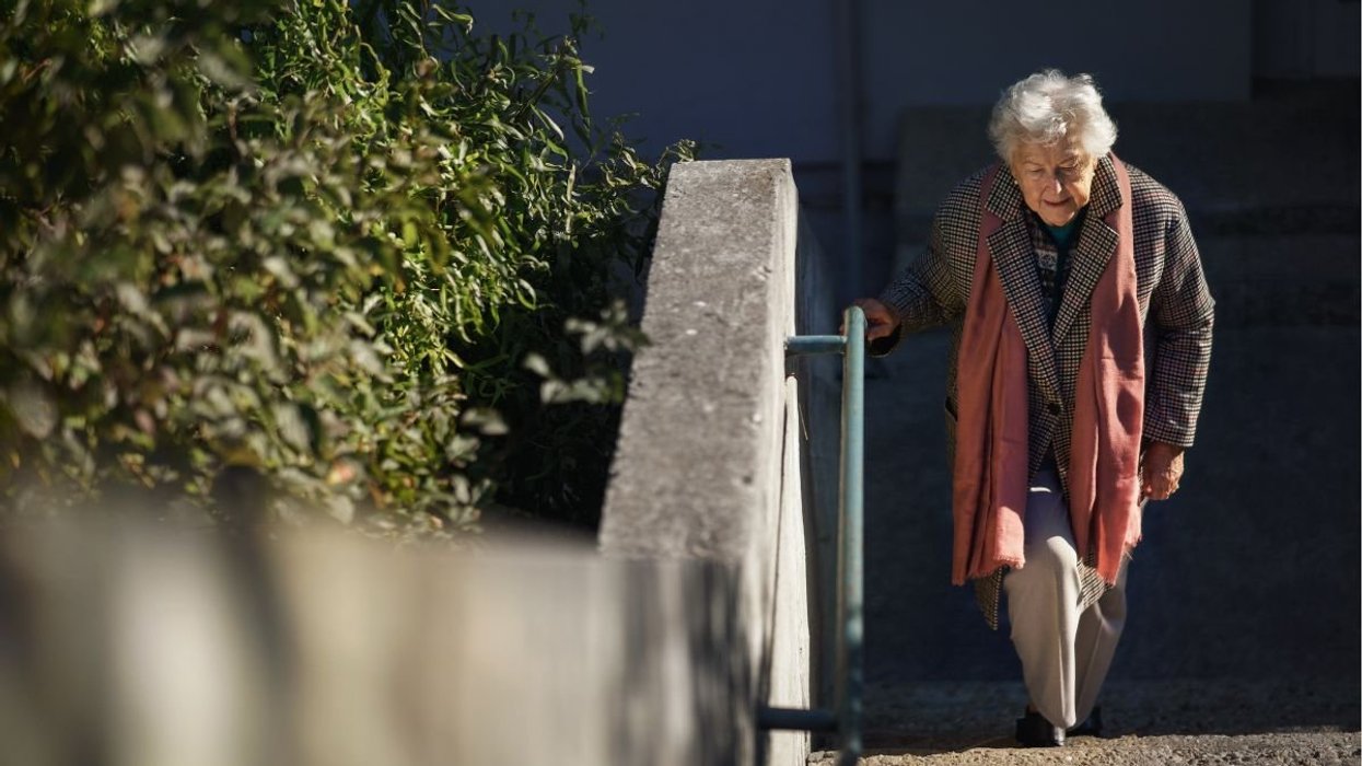 SENIOR FEMALE CLIMBING STAIRS
