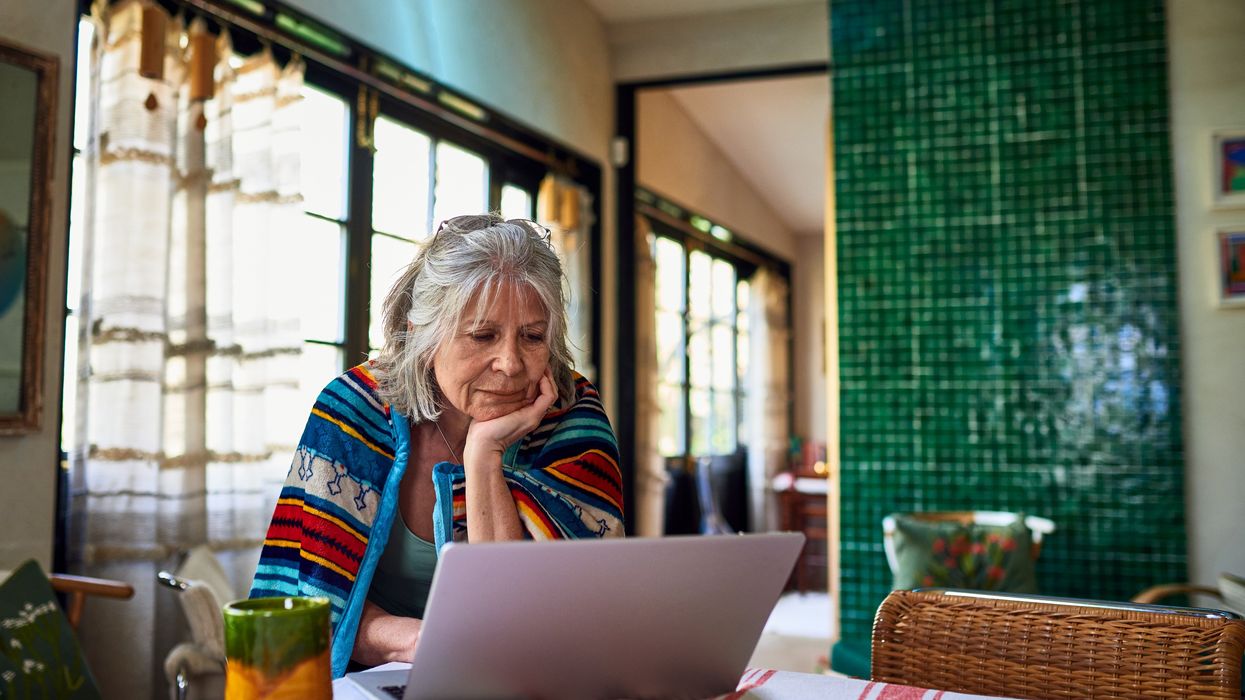 Senior looks at laptop