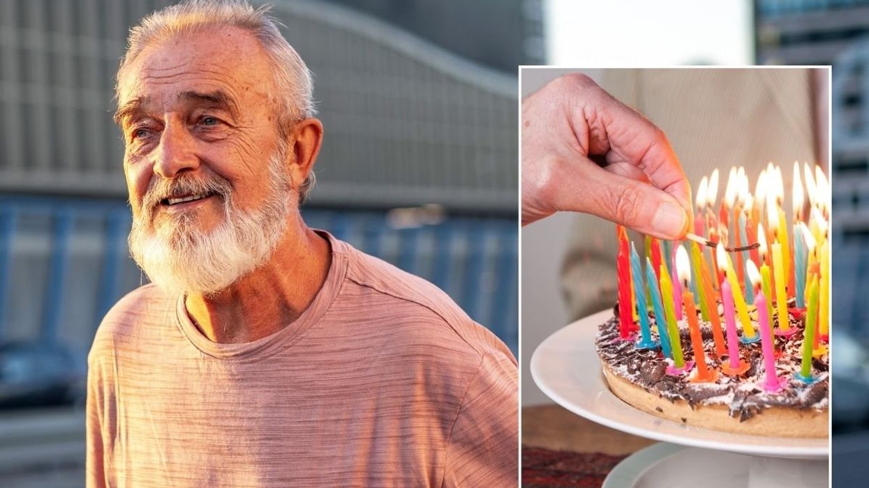 SENIOR MAN AND BIRTHDAY CAKE CANDLES