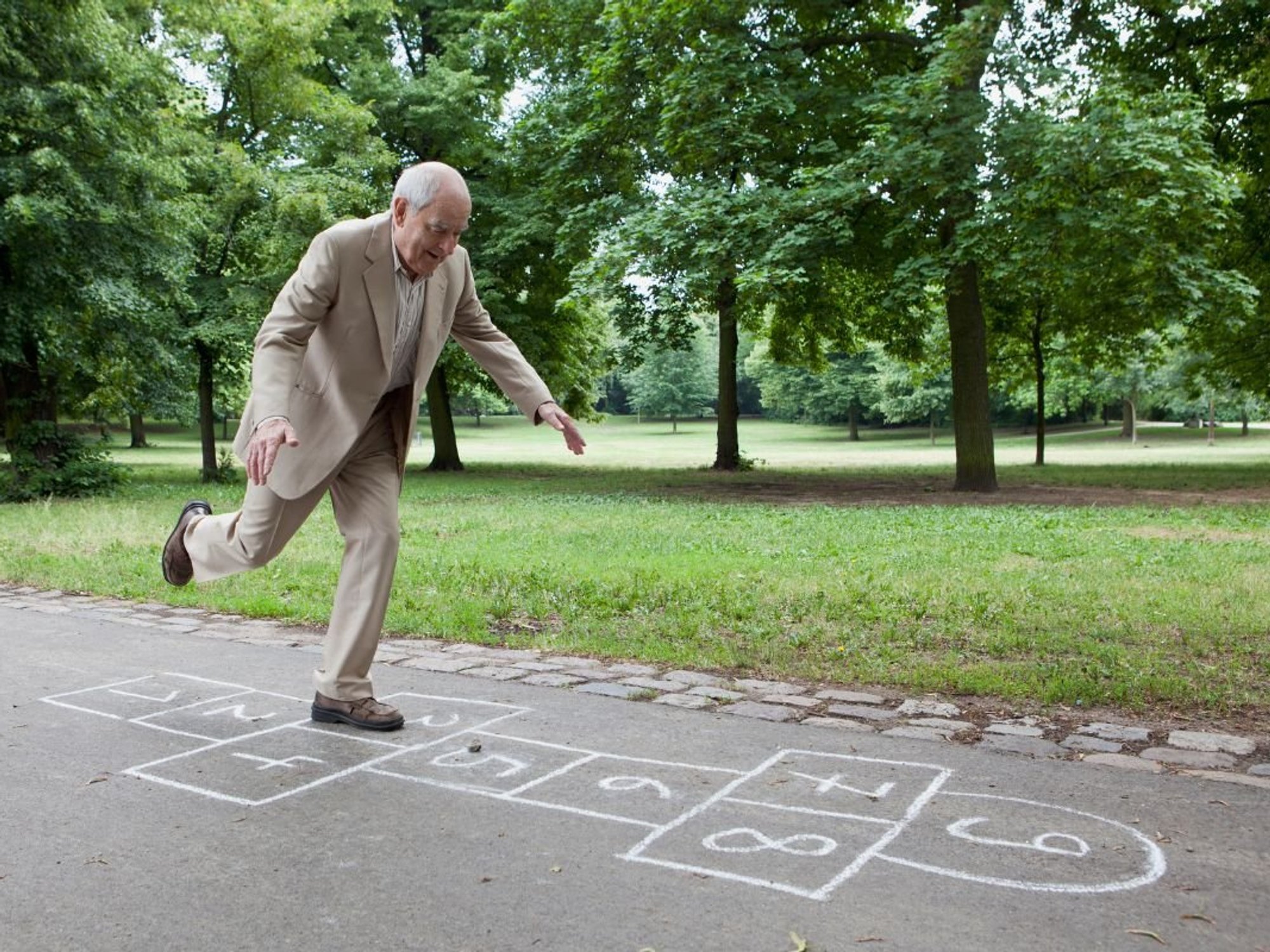 SENIOR MAN DOING HOPSCOTCH
