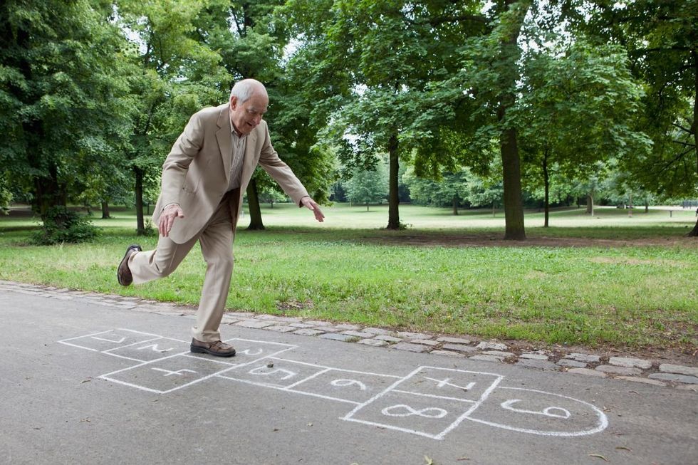 SENIOR MAN DOING HOPSCOTCH