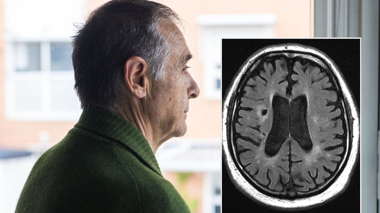 Senior man looking out window