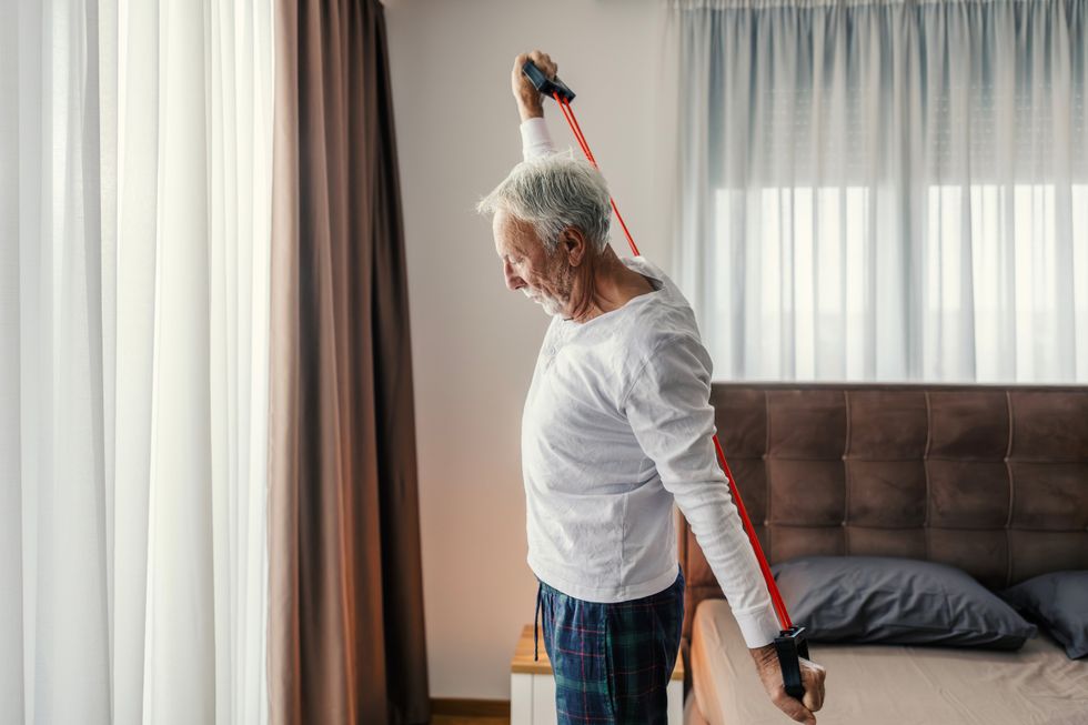 senior man using resistance training