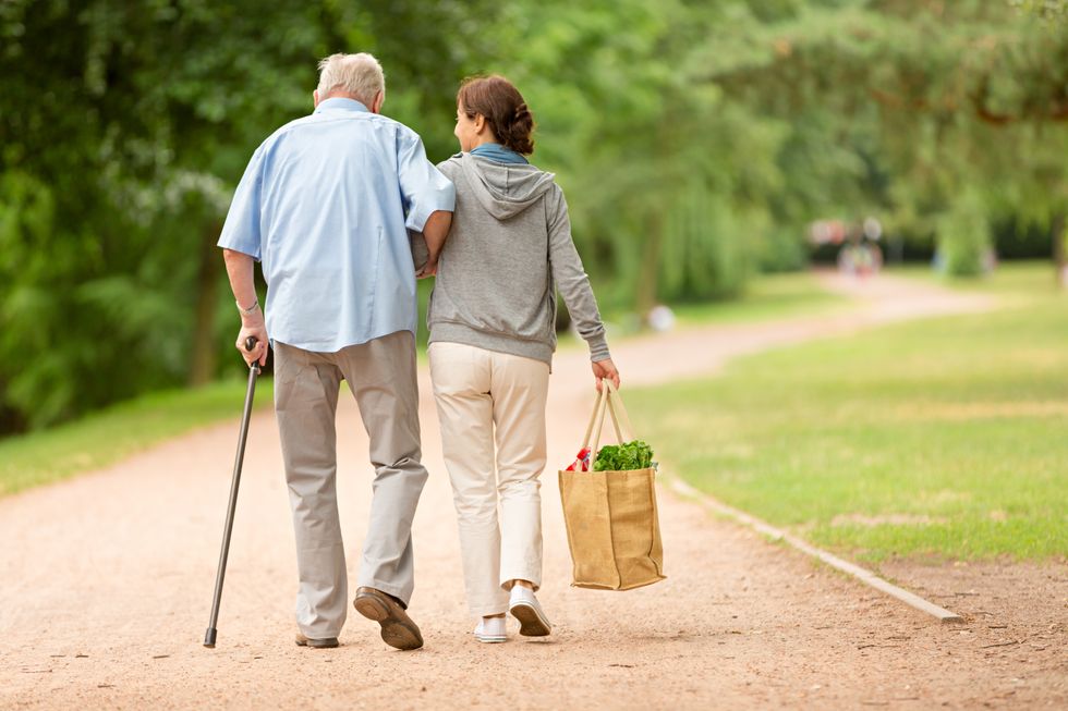 Senior man walking with woman outside