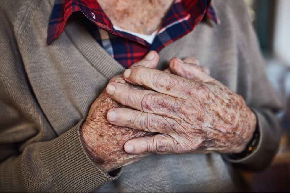 Senior man with hands over heart