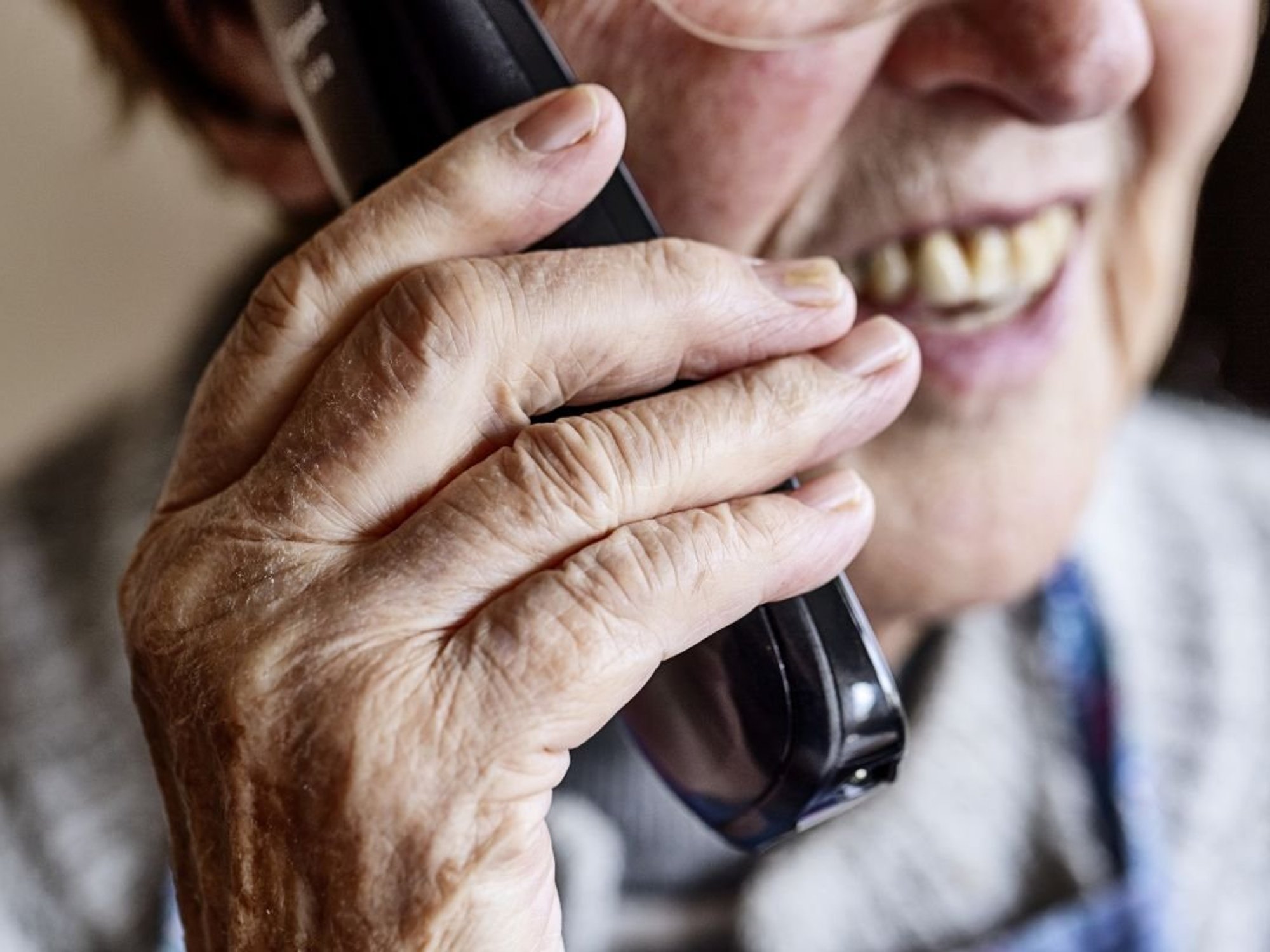 SENIOR PERSON SPEAKING ON PHONE