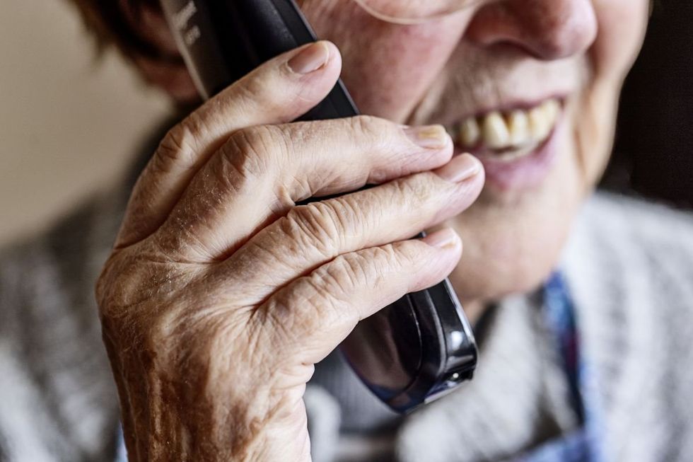 SENIOR PERSON SPEAKING ON PHONE