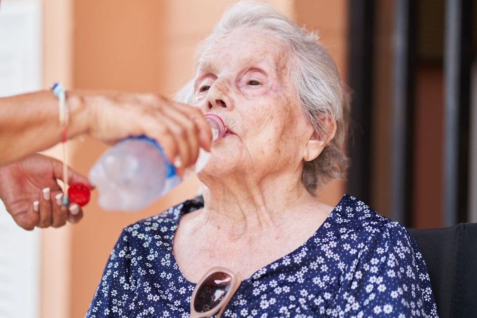 SENIOR WOMAN DRINKING