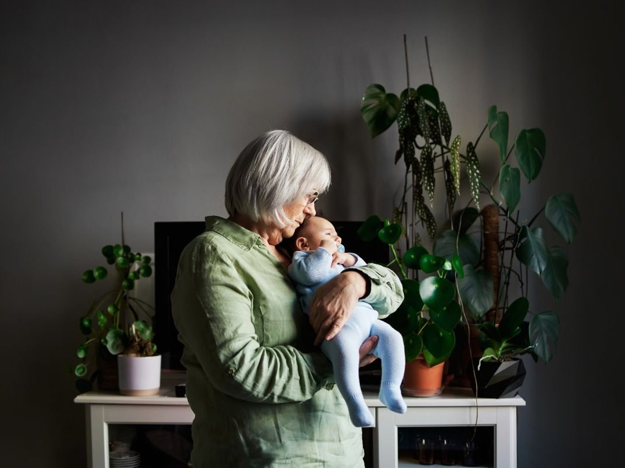 SENIOR WOMAN HOLDING BABY