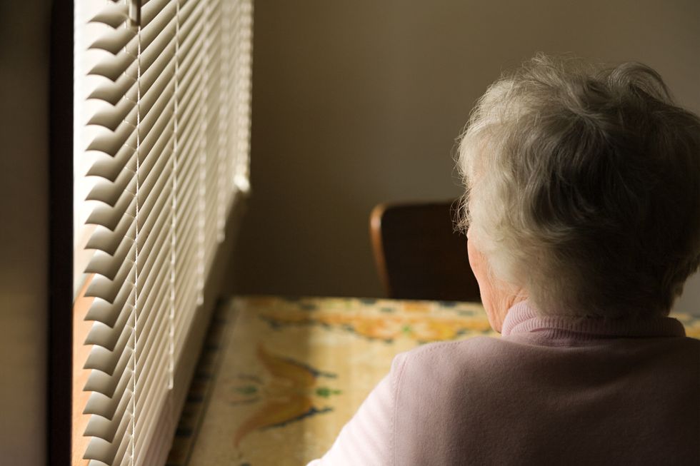 Senior woman sitting by window