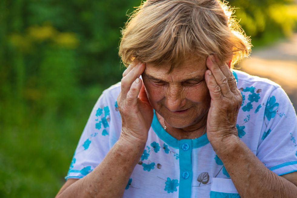Senior woman with her head in her hands