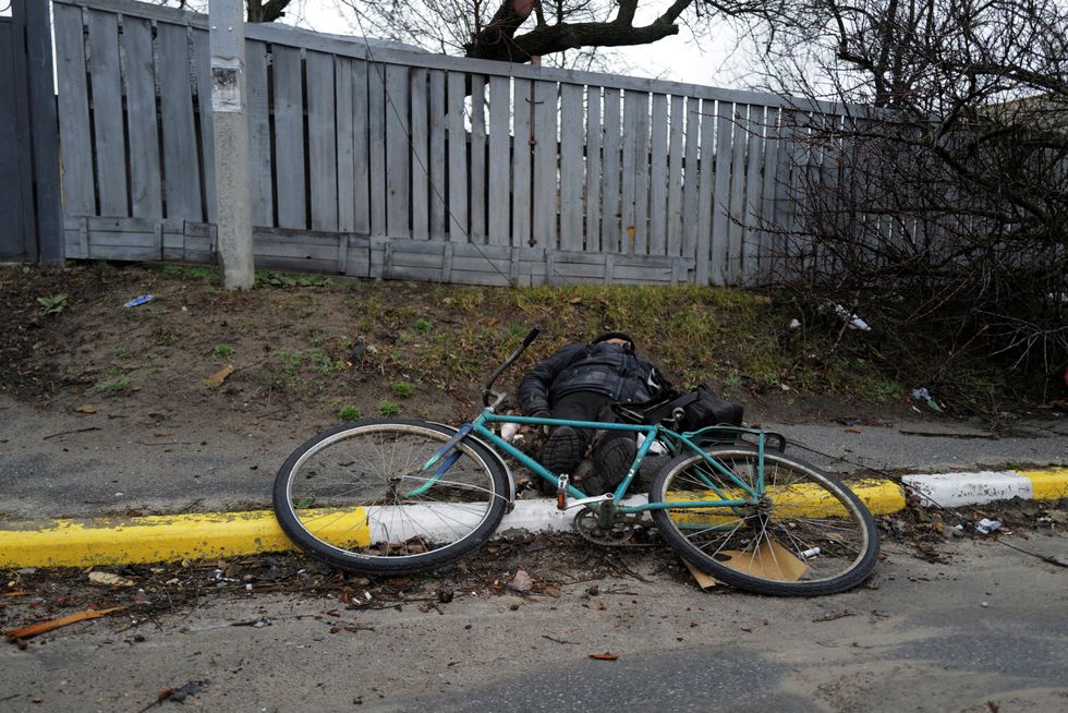 SENSITIVE MATERIAL. THIS IMAGE MAY OFFEND OR DISTURB. The body of a civilian, who according to residents was killed by Russian army soldiers, lies in the street, amid Russia's invasion of Ukraine, in Bucha, in Kyiv region, Ukraine April 2, 2022. Picture taken April 2, 2022. REUTERS/Zohra Bensemra