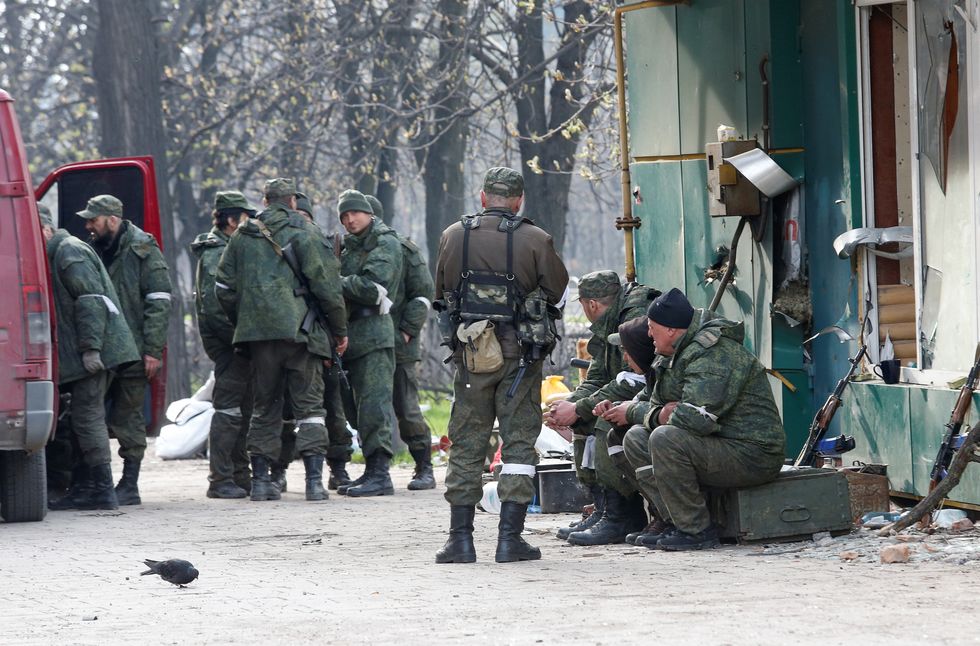 Service members of pro-Russian troops gather in a street during Ukraine-Russia conflict in the southern port city of Mariupol