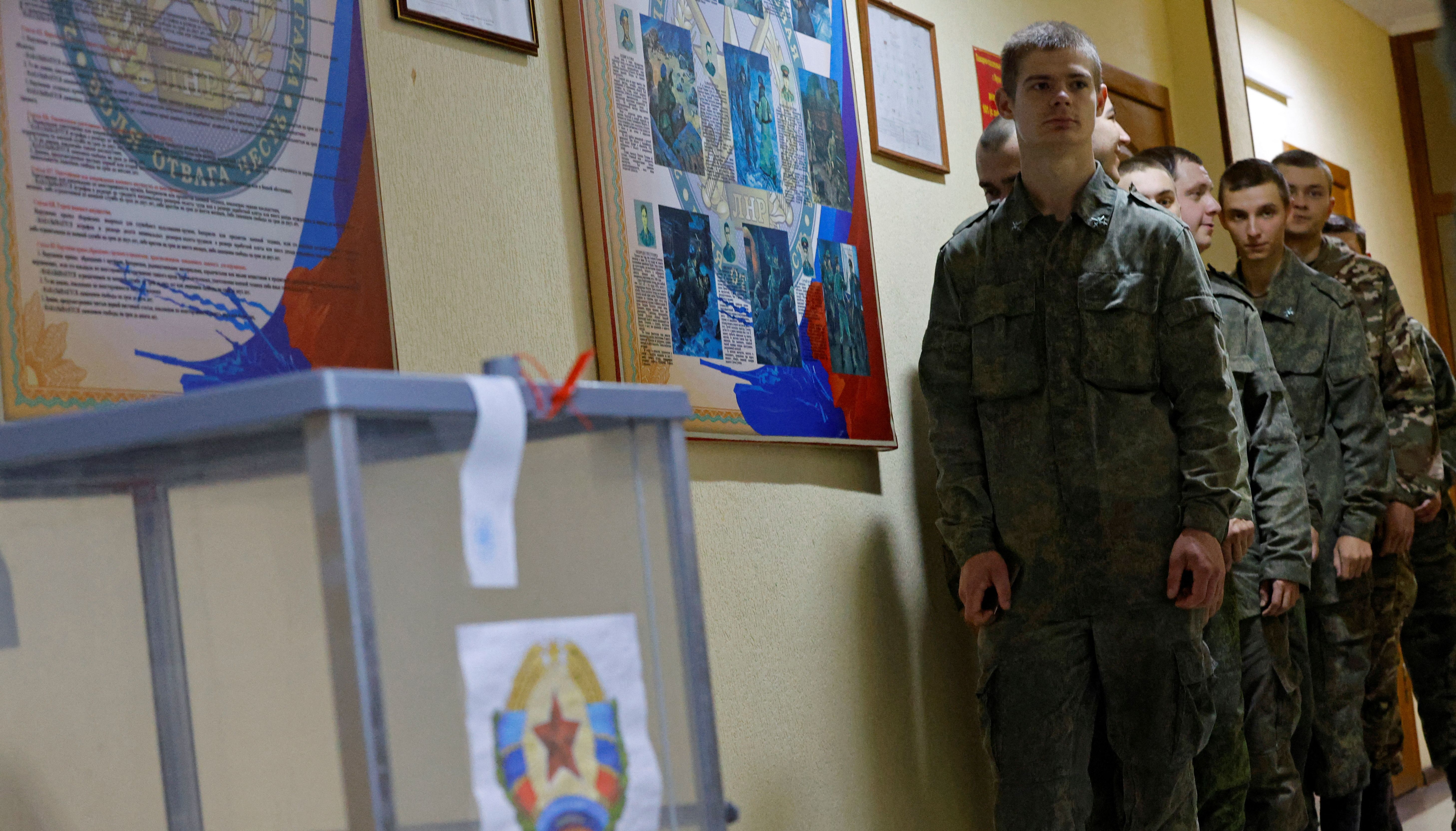 Service members of the self-proclaimed Luhansk People's Republic line up to vote during a referendum on joining LPR to Russia, at a military facility in Luhansk, Ukraine