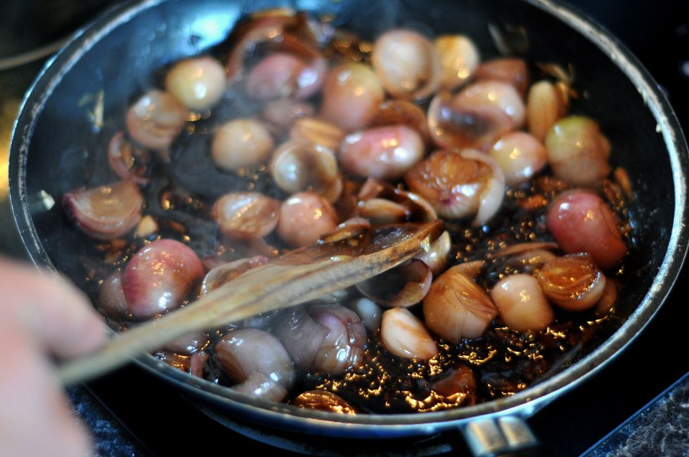 Shallots cooking in a pan
