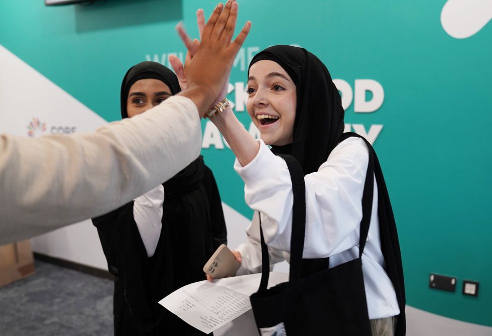 Shannon Rostam (right) receiving her GCSE results at Rockwood Academy secondary school in Alum Rock, Birmingham