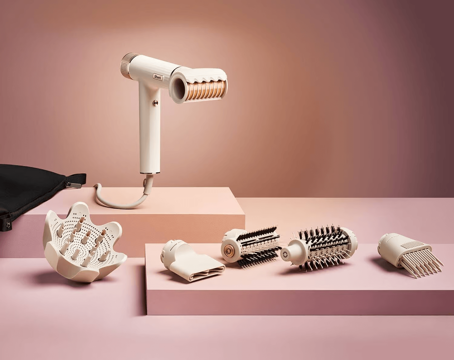 shark speedstyle hair dryer and styler with the five attachments littered around it