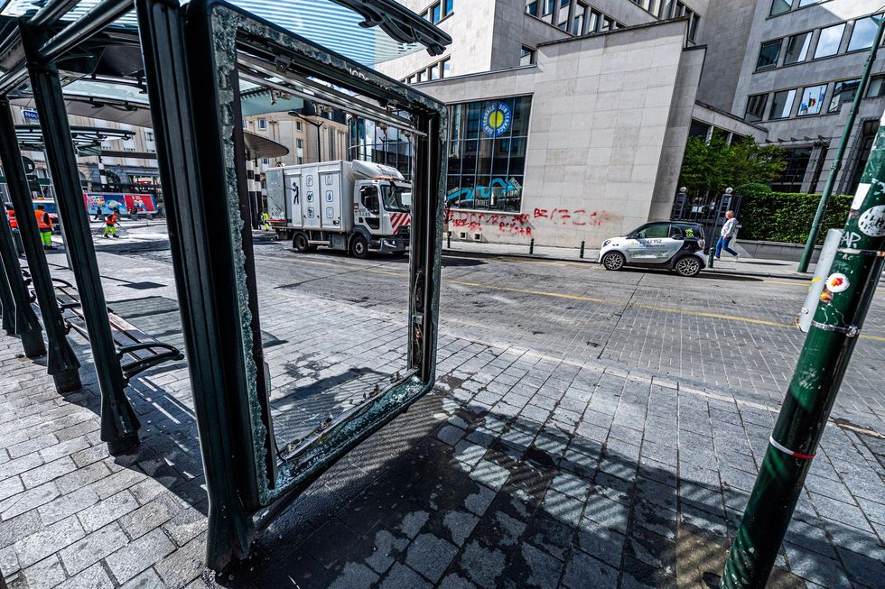 Shattered bus stop in Brussels after education reform protest