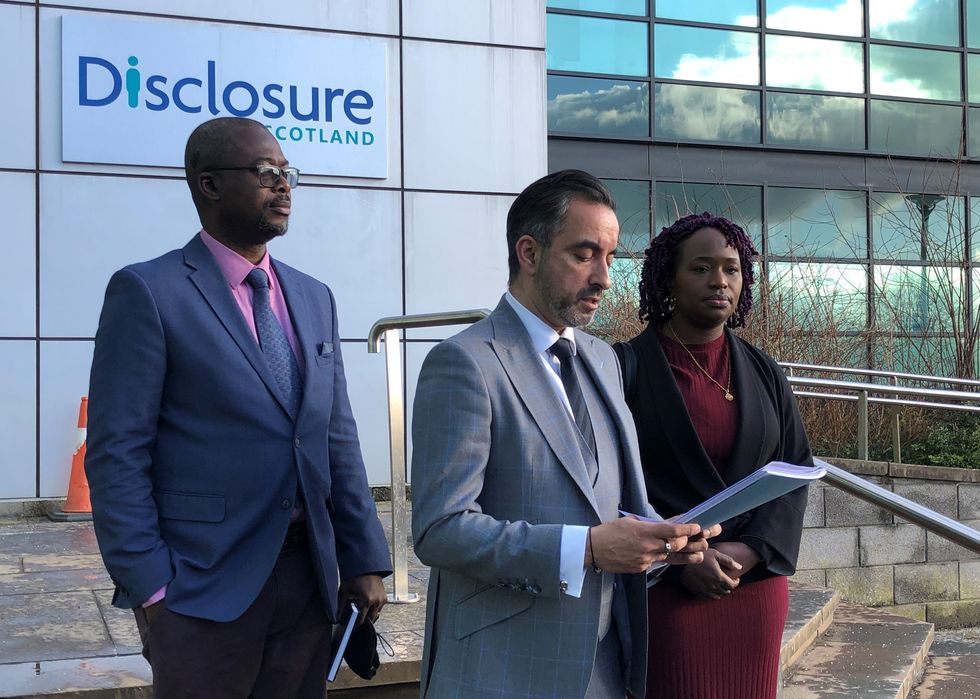 Sheku Bayoh's sister Kadijatu Johnson (right) , brother in law Adie Johnson (left) and family solicitor Aamer Anwar (centre)