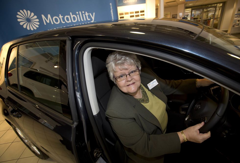 Shirley Lynam sits in her new Motability car at the Hayselden Volkswagen dealership in Doncaster, Yorkshire, having been presented with the car by Ed Miliband