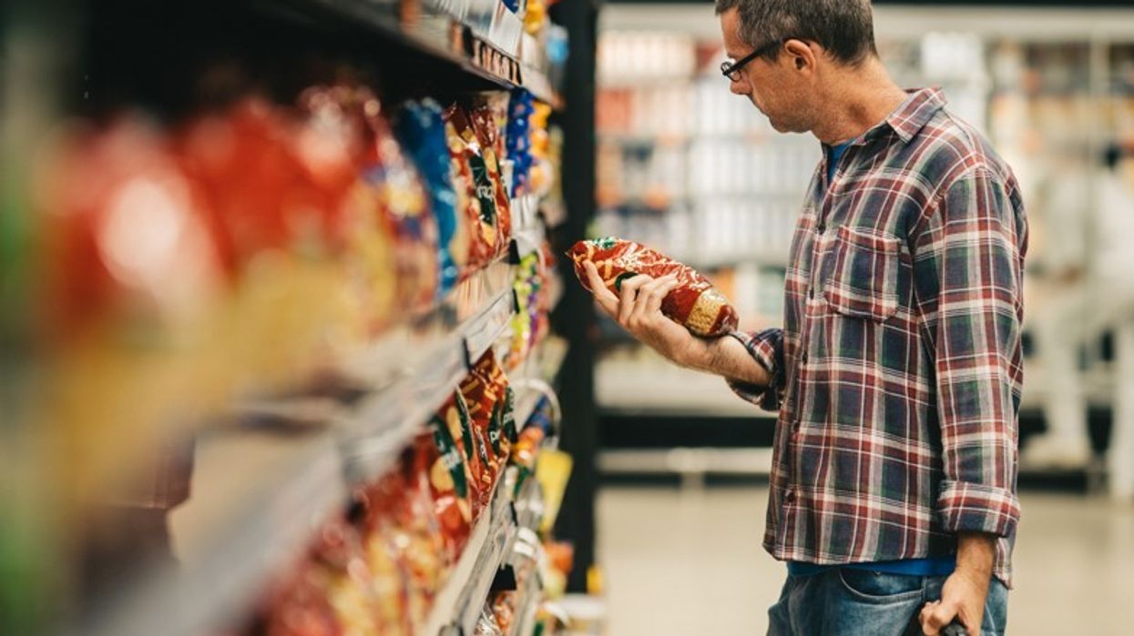 shopper holding crisps