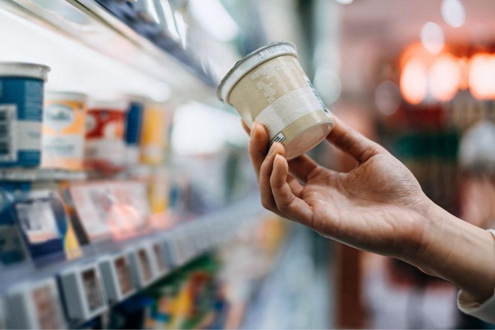 SHOPPER INSPECTING SUPERMARKET PRODUCT