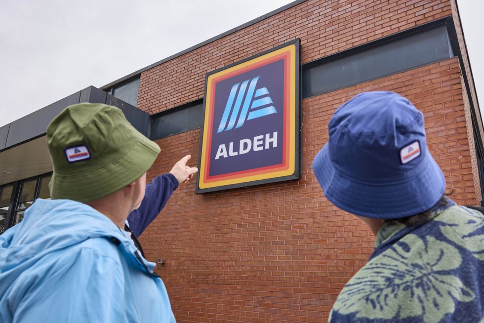 Shoppers pointing to 'Aldeh' store sign