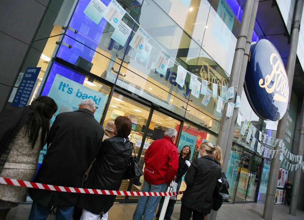 Shoppers queue outside the Boots flagship store in Oxford Street, central London
